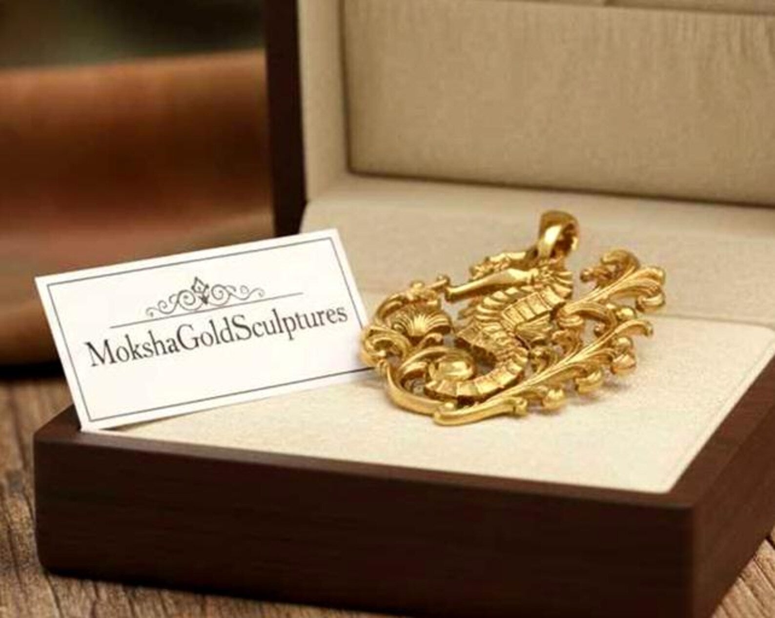 Seahorse pendant necklace in gold, silver, and brass finish by MokshaGoldSculptures displayed in a jewelry box.