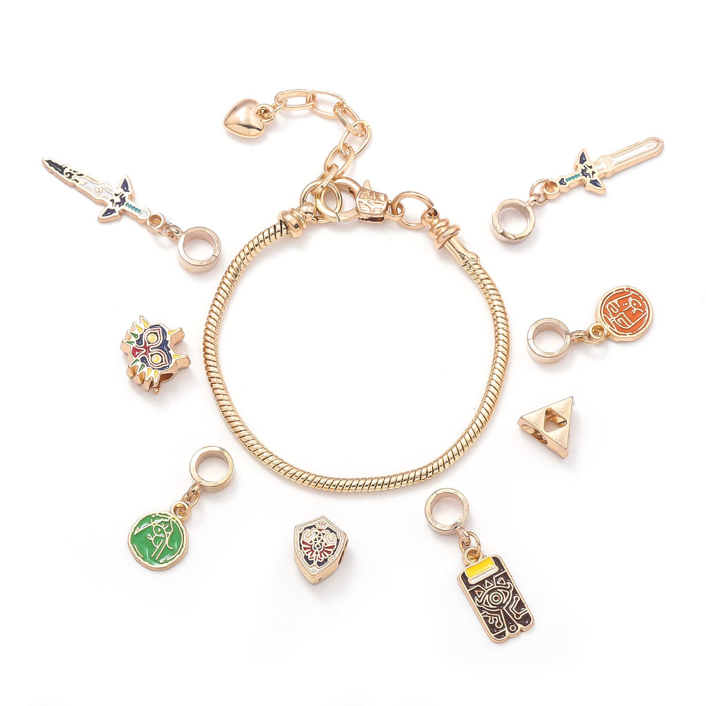Legend of Zelda Charm Bracelet in silver-tone by MokshaGoldSculptures with eight Breath of the Wild charms including sword and shield.