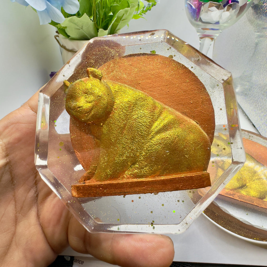 Handmade Panda Resin Coaster by MokshaGoldSculptures, featuring black and white animal art, held in hand.