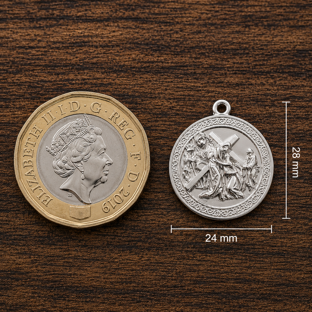 Jesus Carrying the Cross pendant in 925 sterling silver by MokshaGoldSculptures, shown beside a 2019 one-pound coin.