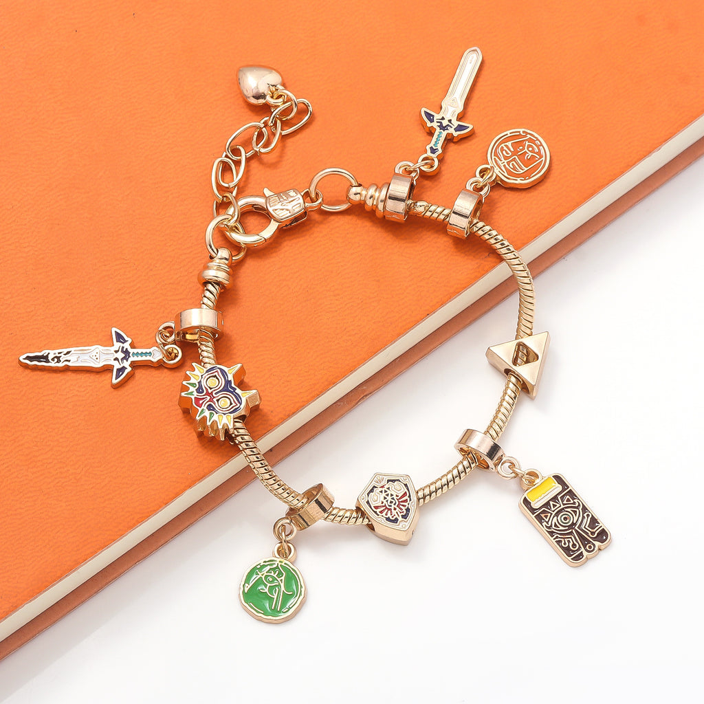 Legend of Zelda Charm Bracelet – Breath of the Wild in silver finish by MokshaGoldSculptures with seven themed charms.