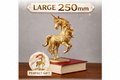 The Golden Unicorn Statue in gold finish by MokshaGoldSculptures, 250mm, displayed on a book against a gray backdrop.