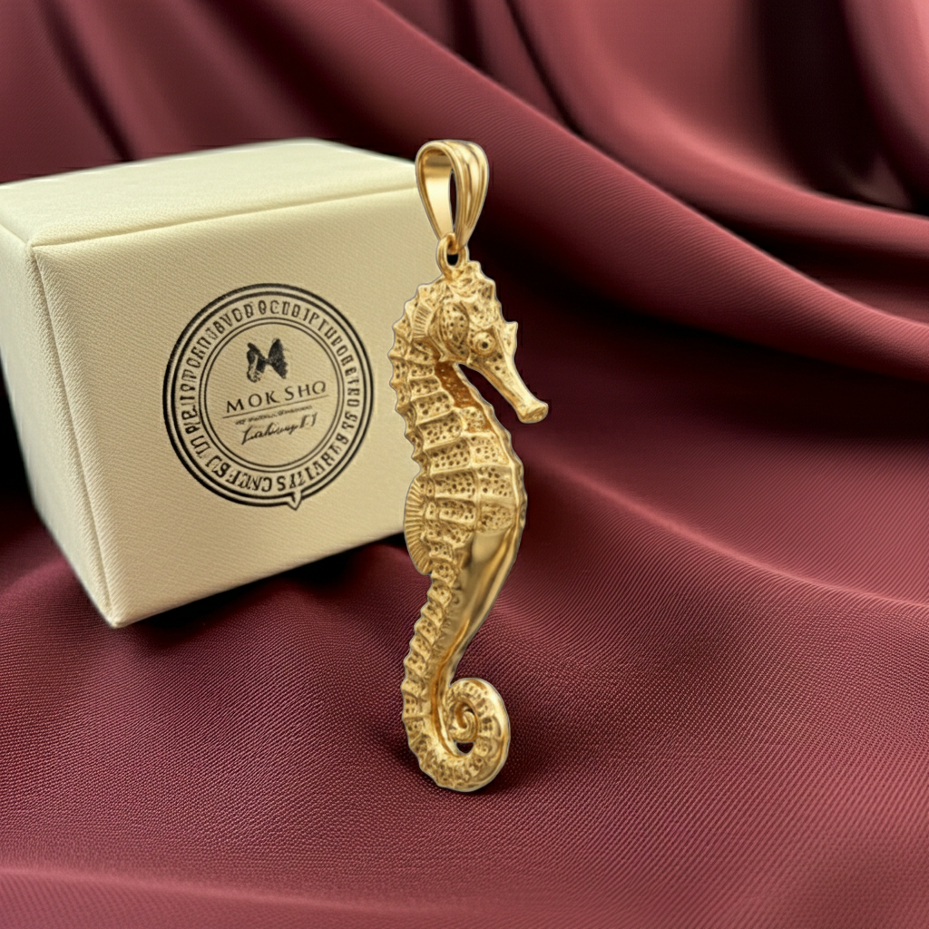 Seahorse Pendant Necklace in gold by MokshaGoldSculptures beside ivory Moksho box, Ocean Jewellery collection.