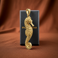 The Seahorse Pendant Necklace in gold, silver & brass by MokshaGoldSculptures, shown with elegant branded packaging.