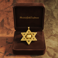 Star of David pendant necklace in 18K gold by MokshaGoldSculptures, shown in a brown velvet box.
