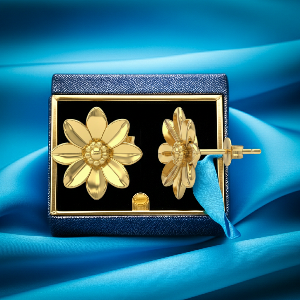 Polished Brass Flower Stud Earrings by MokshaGoldSculptures, nature-inspired, in a dark blue jewelry box on vibrant blue fabric.