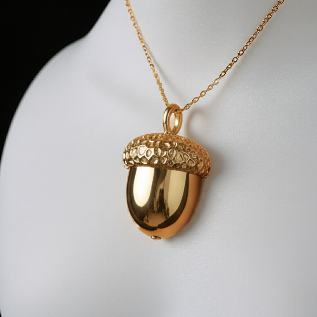 Gold Acorn Pendant Necklace in 24K gold plated finish by MokshaGoldSculptures, displayed on a white bust.