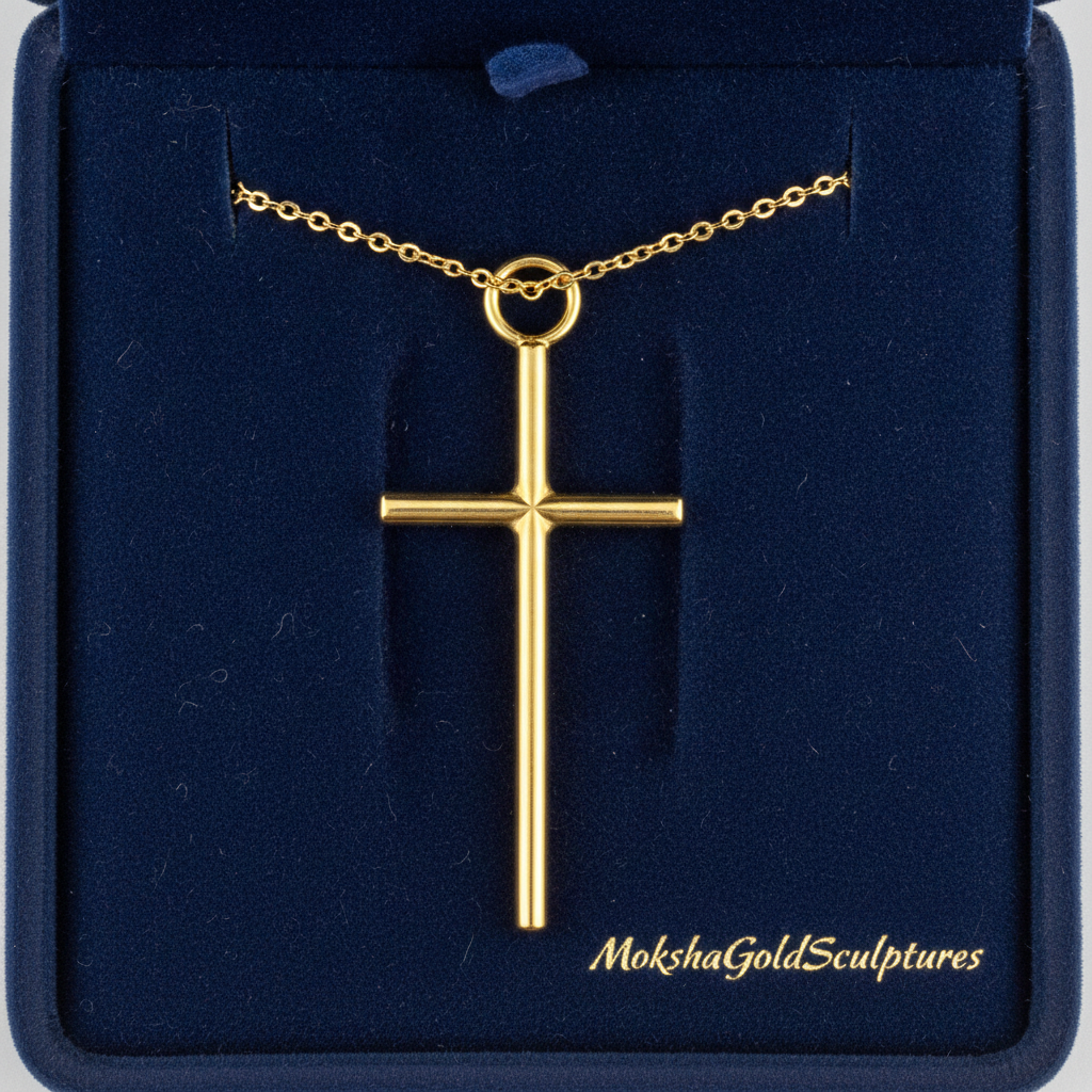The Minimalist Cross Pendant Necklace in 9K gold by MokshaGoldSculptures, shown in a dark blue velvet box.