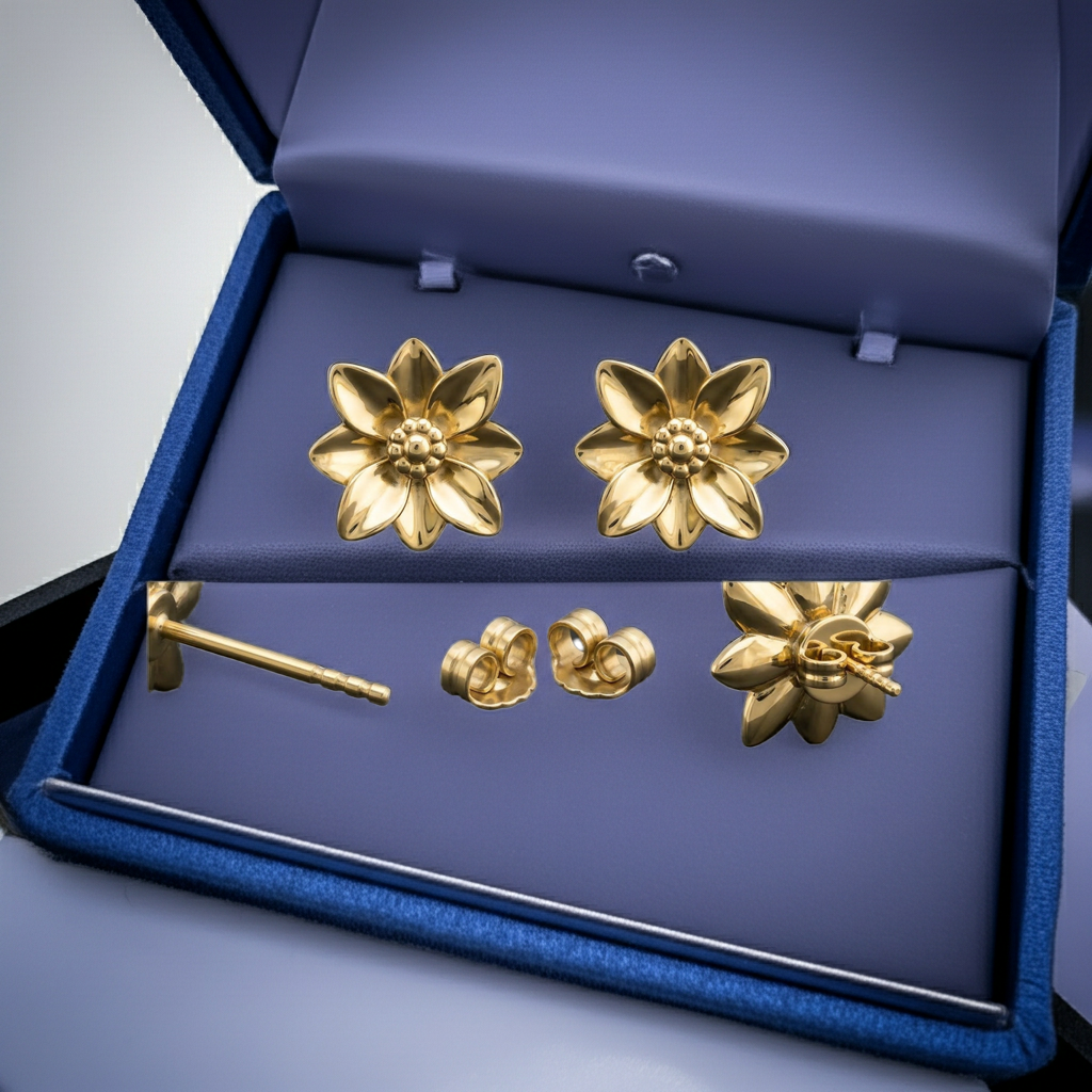 Polished brass flower stud earrings by MokshaGoldSculptures in a blue box with purple cushion, nature-inspired design.