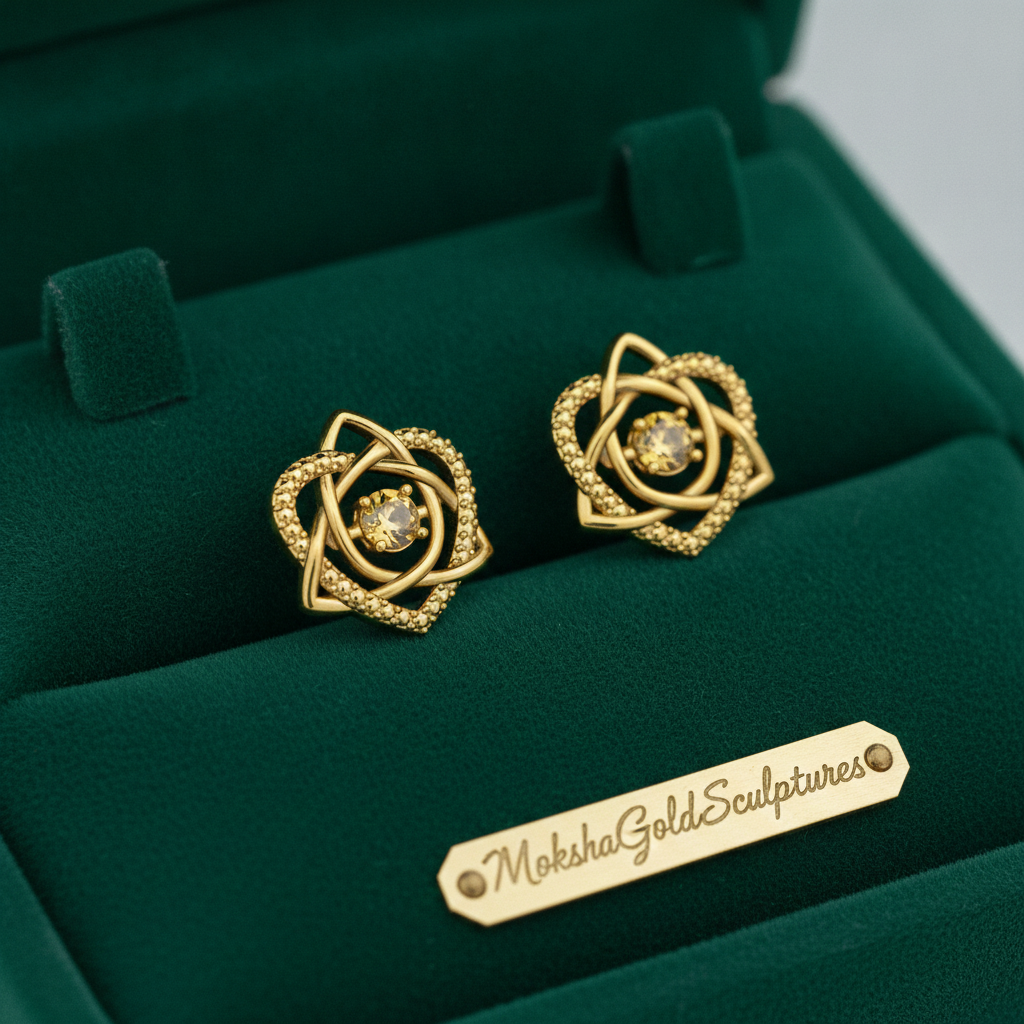 Celtic Trinity Knot Heart Stud Earrings in 9K gold by MokshaGoldSculptures, shown in a green velvet jewelry box.