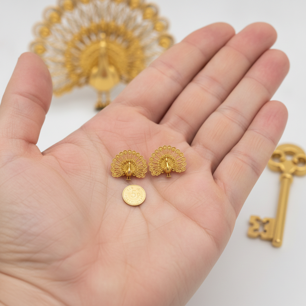 Peacock Stud Earrings in gold-tone finish by MokshaGoldSculptures, fan-tail shape, shown beside a coin for scale.