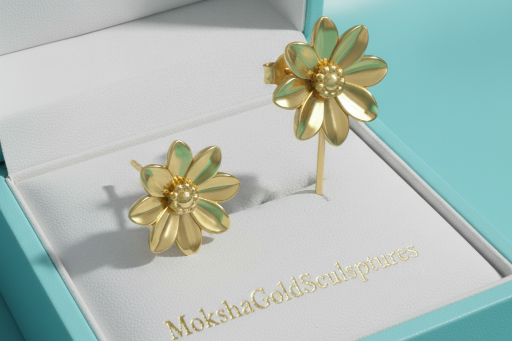 Flower stud earrings in polished brass finish by MokshaGoldSculptures, shown in a white box with gold brand embossing.