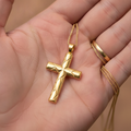 Faceted Cross Pendant Necklace in 9K gold by MokshaGoldSculptures, shown on hand with a simple gold ring.