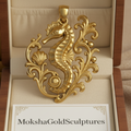 Seahorse Pendant Necklace in gold finish by MokshaGoldSculptures displayed in an open jewelry box.