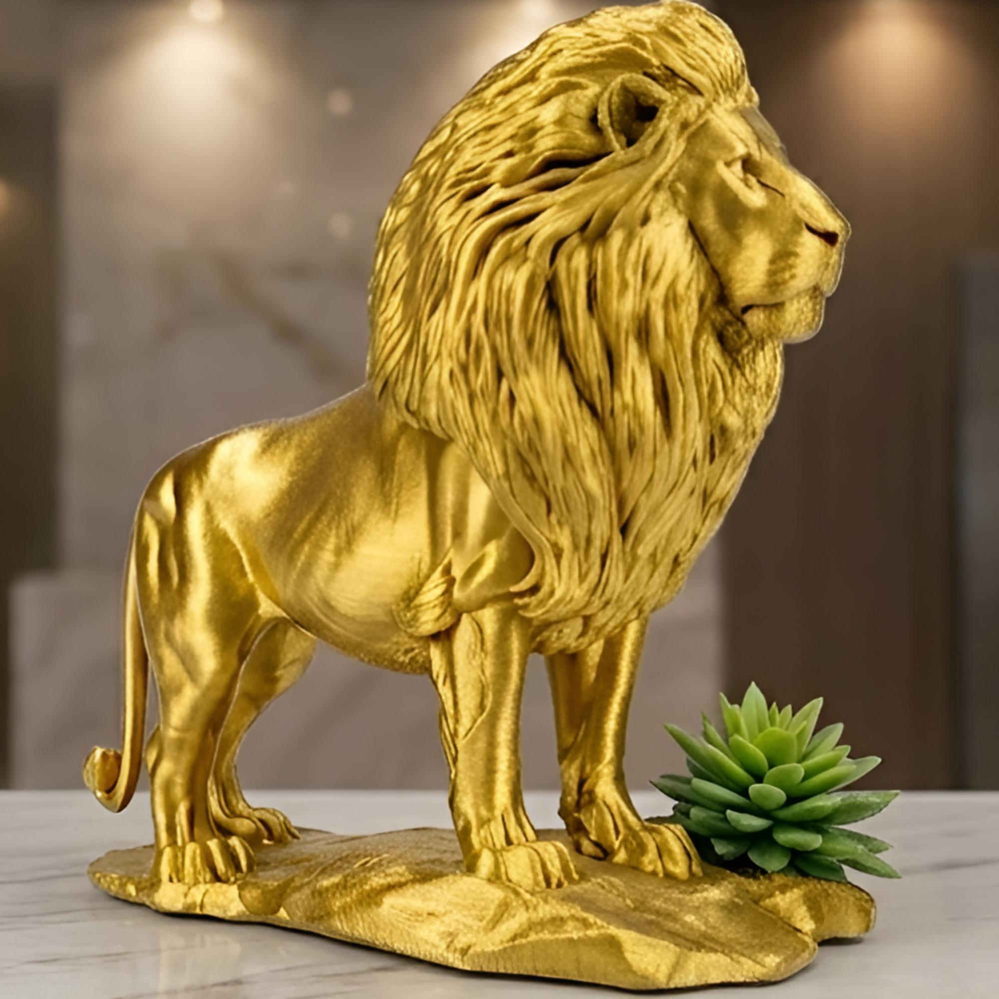 The Gold Lion Statue on Rock in metallic PLA by MokshaGoldSculptures, sleek finish, desk decor beside a green succulent.